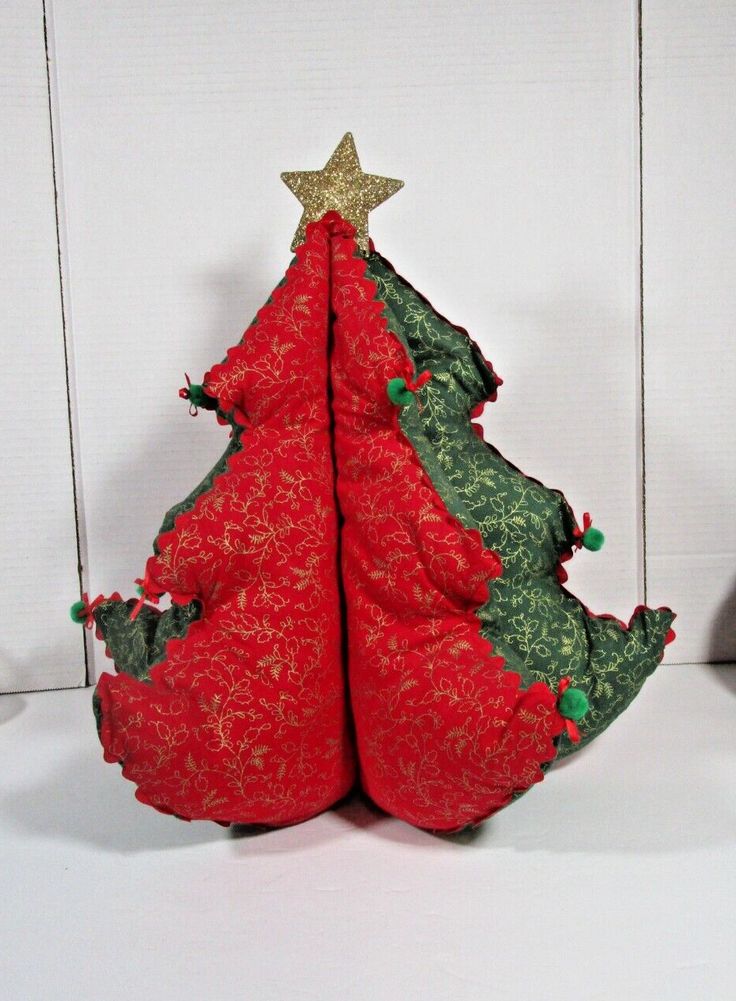 a red and green christmas tree sitting on top of a white table