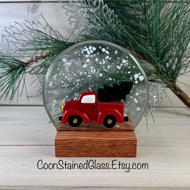 a snow globe with a red truck in it