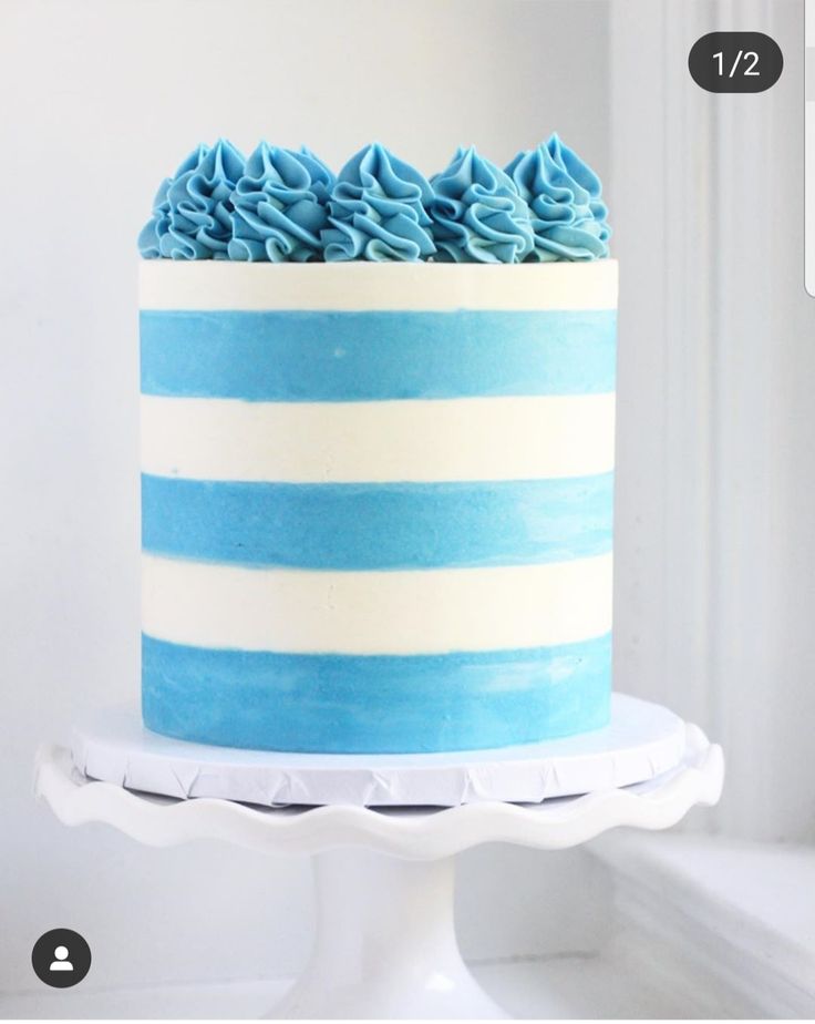 a blue and white striped cake with frosting