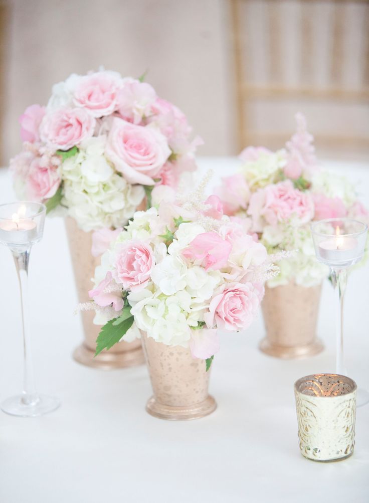 pink and white flowers in vases on a table