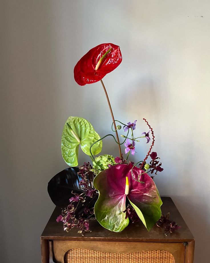 a flower arrangement sitting on top of a wooden table