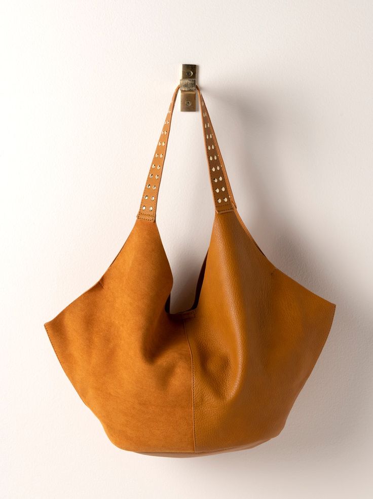 Indulge in the elegant simplicity of Shiraleah's Ryker Tote. This women's tote bag, crafted from pebble grain PU and suede PU, is a testament to the brand's focus on detail and quality. Ideal for the fall/winter season, this tote is not just a bag, it's a lifestyle statement. A thoughtful gift for yourself or a loved one, it reflects the specialness that Shiraleah believes in. Pair with other items from Shiraleah to complete your look! Color: Honey L 24" × W 5.5" × H 11"; Hnd 8" Pebble Grain Pu Chic Suede Bag For On-the-go, Chic Double Handle Suede Shoulder Bag, Chic Suede Shoulder Bag With Double Handle, Chic Suede Shopping Bag, Chic Suede Hobo Bag With Removable Pouch, Chic Suede Hobo Bag With Soft Leather, Chic Suede Bags With Soft Leather, Chic Suede Tote Shoulder Bag, Chic Suede Hobo Bag With Leather Handles