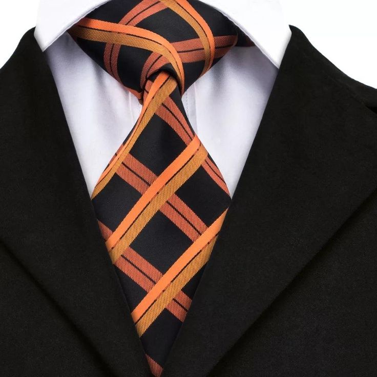 This set is ideal for business professionals, groomsmen, or anyone looking to add a touch of class to their formal attire. The black and orange color combination is bold and eye-catching, making it the perfect choice for anyone looking to make a statement at their next formal event. Whether you're attending a wedding, a black tie event, or a business meeting, the Black Orange Tie Set will help you look and feel your best. 100% Silk Handmade Package Includes: Tie, Pocket Square & Cufflinks. Lengt Elegant Orange Tie For Business, Classic Orange Ties For Business, Classic Orange Tie For Business, Black Suit And Tie Accessories For Business Meetings, Orange Formal Suit And Tie Accessories, Elegant Orange Suit And Tie Accessories For Formal Occasions, Classic Black Suit And Tie Accessories For Business, Modern Black Suit And Tie Accessories For Formal Occasions, Classic Black Suit And Tie Accessories For Business Meetings