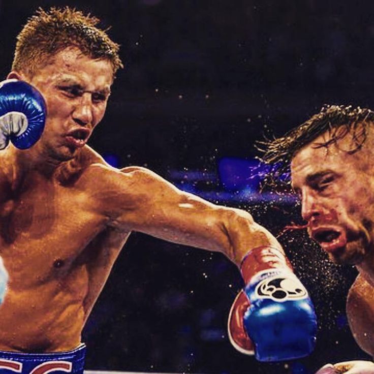 two men are boxing in the ring with each other and one is wearing blue gloves