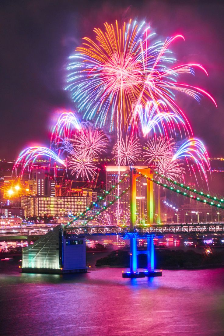 fireworks are lit up in the sky above a city