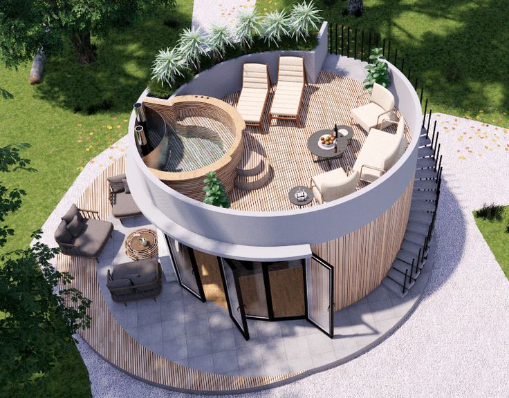 an aerial view of a circular house with outdoor furniture