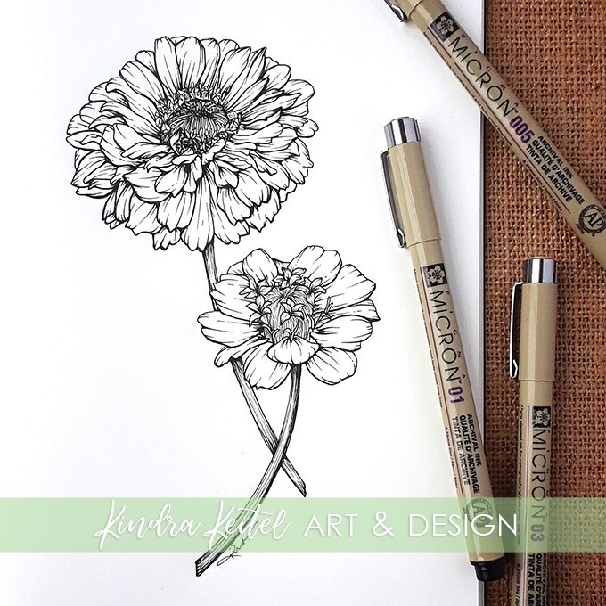 two flowers are drawn on paper with markers