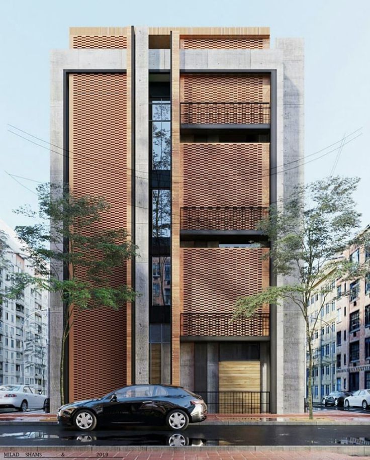 a black car parked in front of a tall building