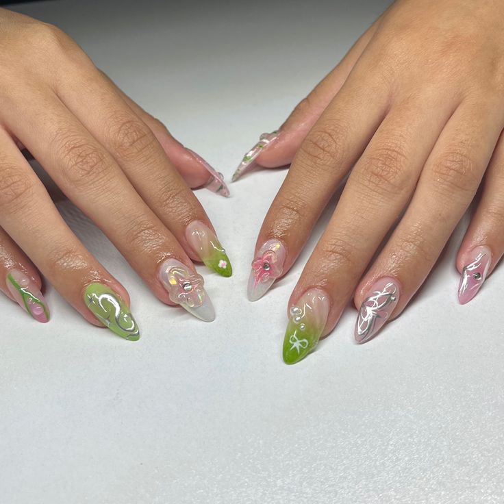 Earth green and pink nails almond with chrome Green And Pink Jelly Nails, Green Pink And Gold Nails, Green Pink Gold Nails, Green Whimsical Nails, Green And Pink Almond Nails, Pink And Green Chrome Nails, Earth Girl Nails, Pink And Green Aura Nails, Light Green Nails With Flowers