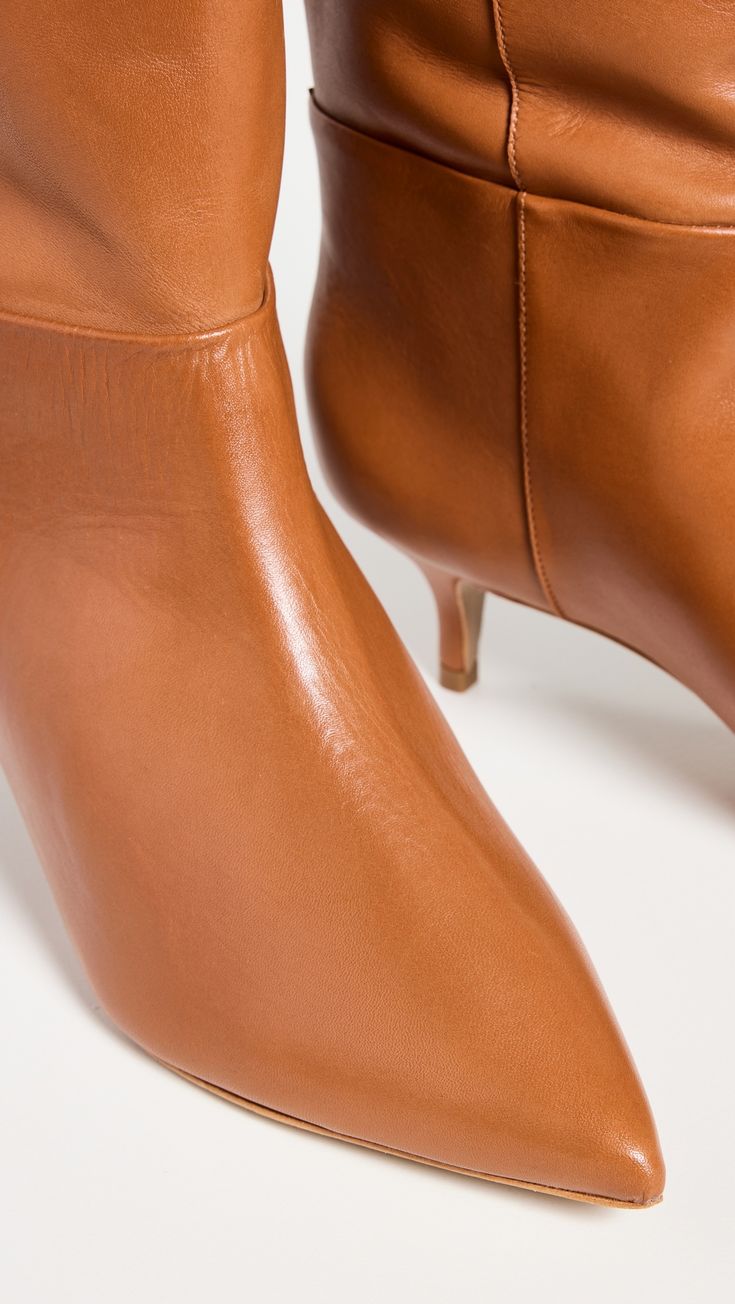 Find SCHUTZ Maryana Lo Wide Boots on Editorialist. Upper: Cowhide. Lining: Leather. No closure, pull-on design. Pointed toe. Leather sole with rubber heel cap. Imported, Brazil. This item cannot be gift-boxed. Measurements: Heel: 2in / 50mm Shaft: 17in / 43cm Circumference: 16.5in / 42cm Designer Heeled Boots With Leather Lining For Fall, Elegant Cognac Heeled Boots For Formal Occasions, Elegant Cognac Calf Leather Heeled Boots, Elegant Cognac Boots With Almond Toe, Elegant Cognac Calf Leather Boots, Designer Almond Toe Boots For Fall, Elegant Cognac Almond Toe Boots, Designer Heeled Boots With Almond Toe For Fall, Elegant Cognac Heeled Boots With Leather Lining