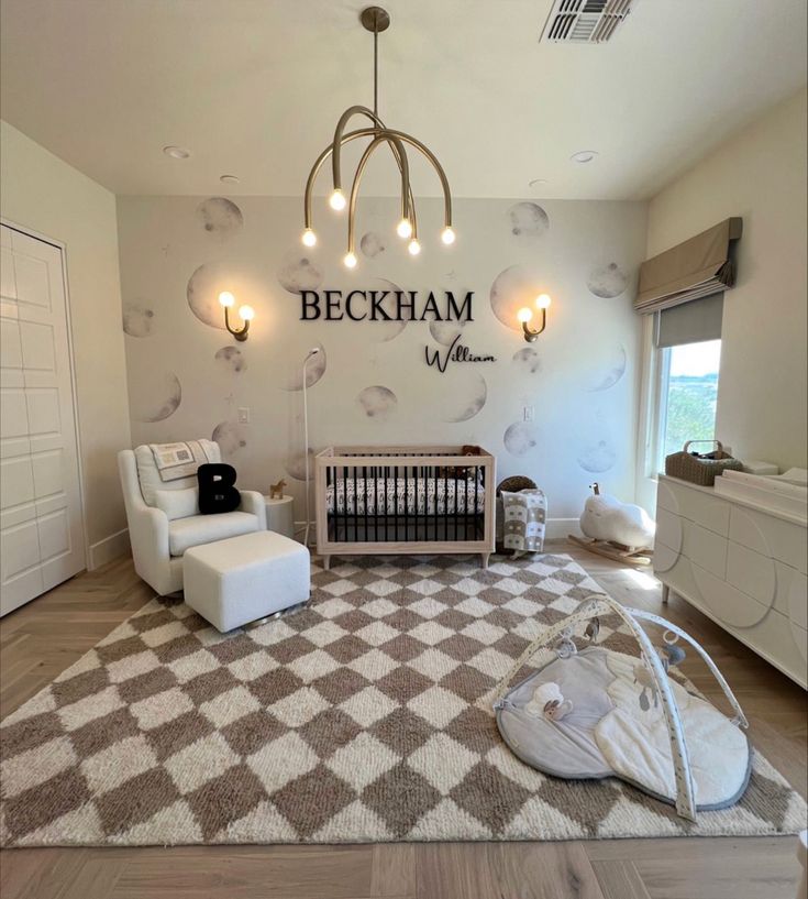 a baby's room with a checkered rug and chandelier