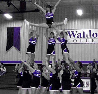 a group of cheerleaders standing on top of each other