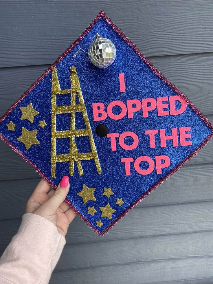 someone is holding up a graduation cap that says i roped to the top