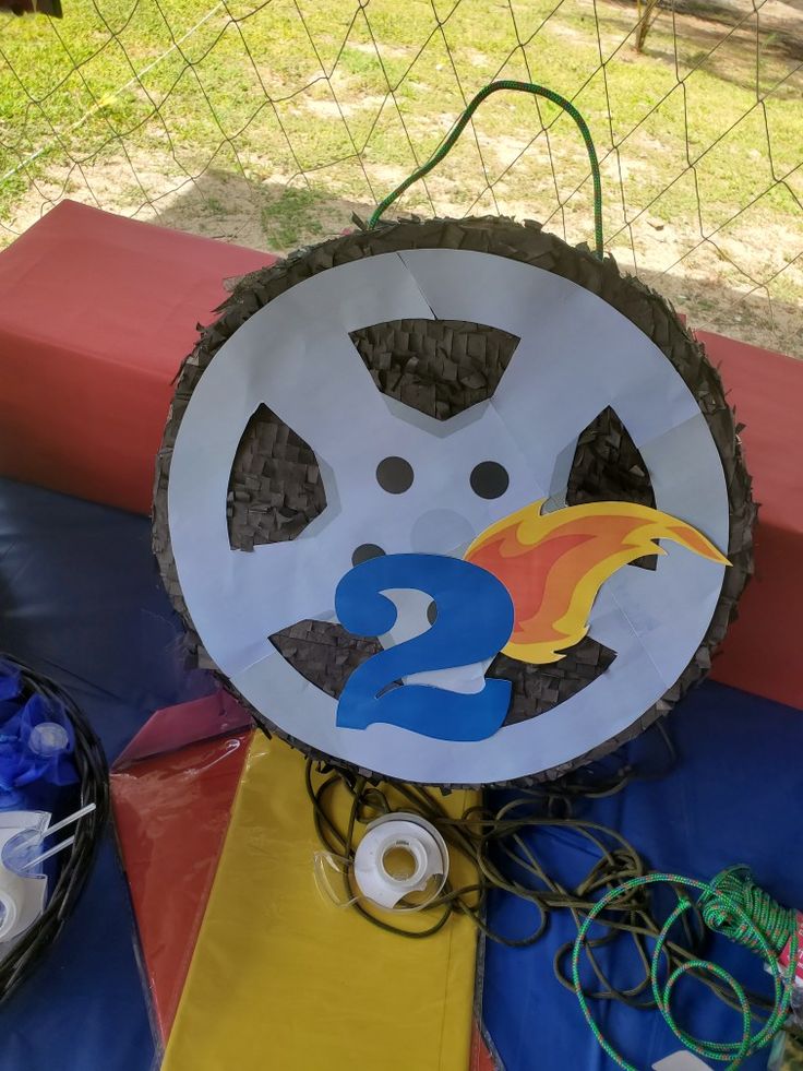 a paper plate with the number two on it next to some wires and other items