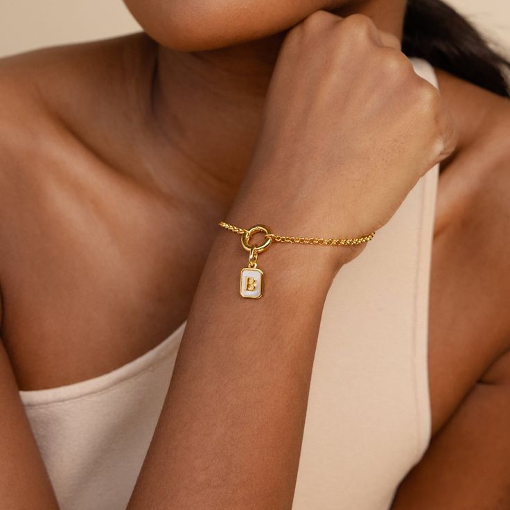 ⚡️Trending Alert: Popular and in high demand ⚡️ Elevate your accessory game with our customizable Mother of Pearl Initial Charm. Versatile and elegant, this charm adds a personalized touch to any necklace, bracelet, hoop earrings, and more, offering endless styling possibilities. Make it uniquely yours or gift it to a loved one by selecting your or their initial, turning this exquisite piece into a cherished keepsake ♡ Material: Vermeil over Brass Finish: 18K Gold Featuring ~9x11mm Mother of Pea Initial Tag Necklace, Sideways Initial Necklace, Dainty Initial Necklace, Birthstone Colors, Gold Letter, Birthstone Gifts, Stud Set, Summer Gift, Circle Necklace