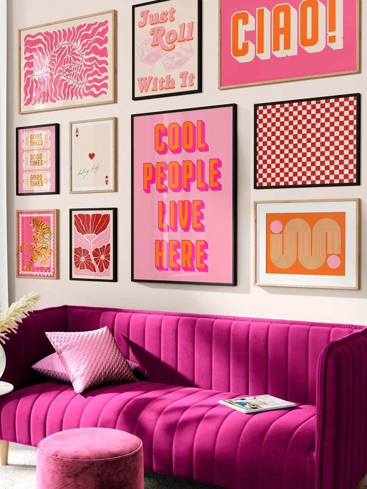 a living room with pink furniture and pictures on the wall