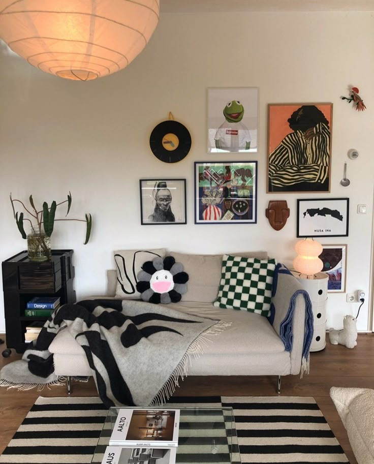 a living room filled with furniture and pictures on the wall