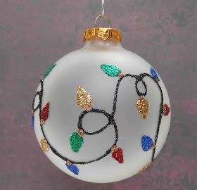 a glass ornament decorated with multicolored beads and leaves on a purple background