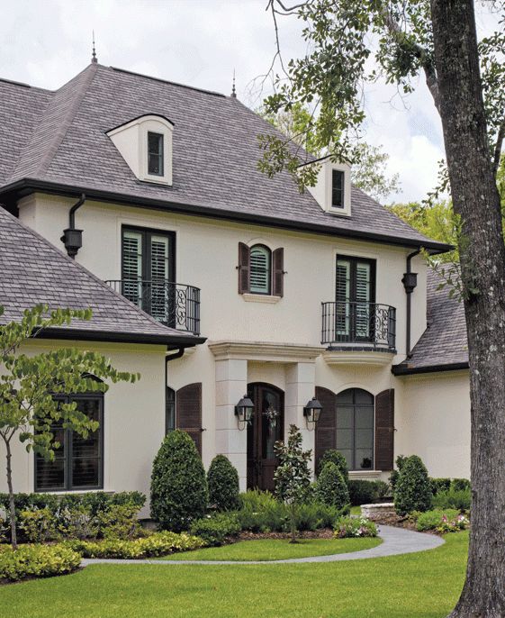 a large white house with black shutters and windows