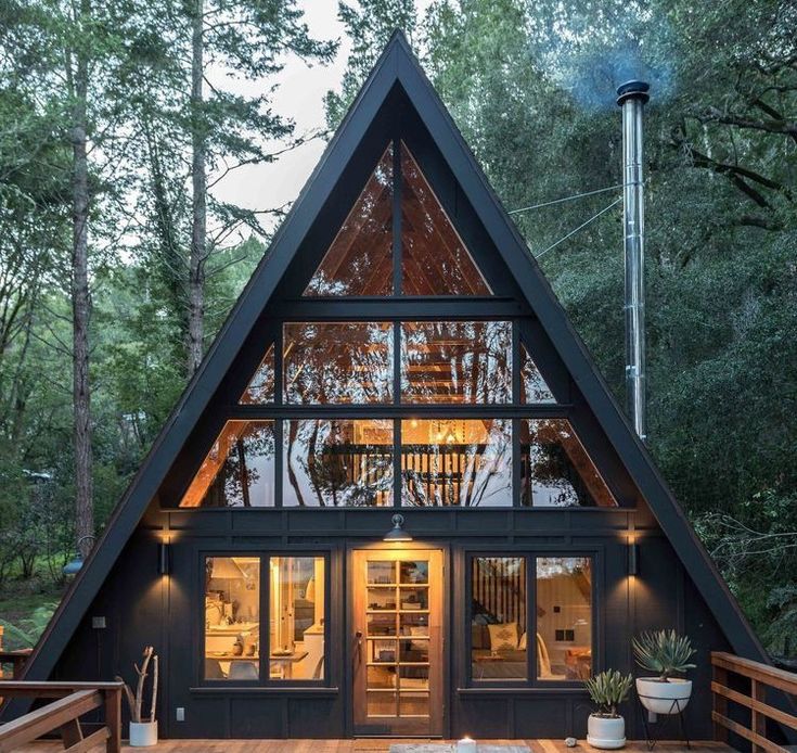 a - frame cabin in the woods at night