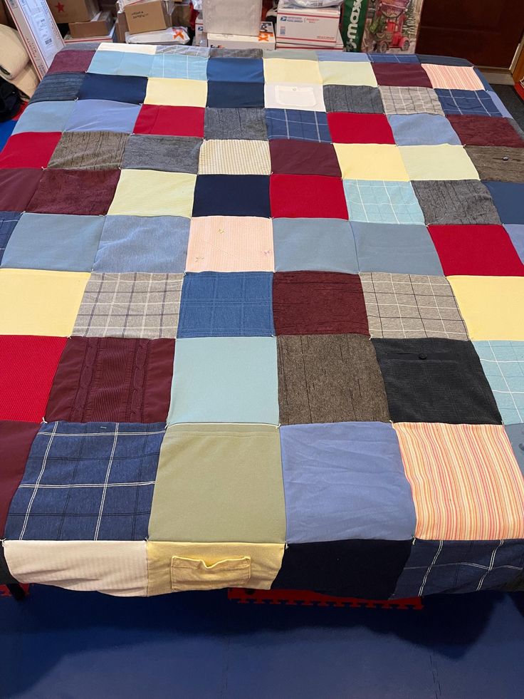 the bed is made with many different colored squares