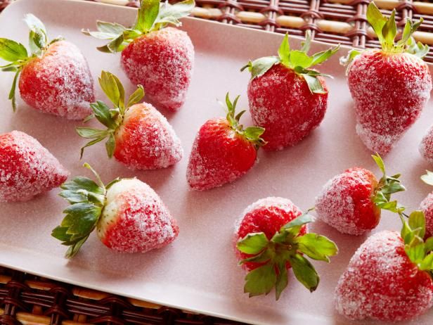 strawberries covered in powdered sugar on a tray