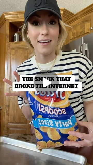 a woman holding up a bag of chips with the caption, the sink that broke the internet