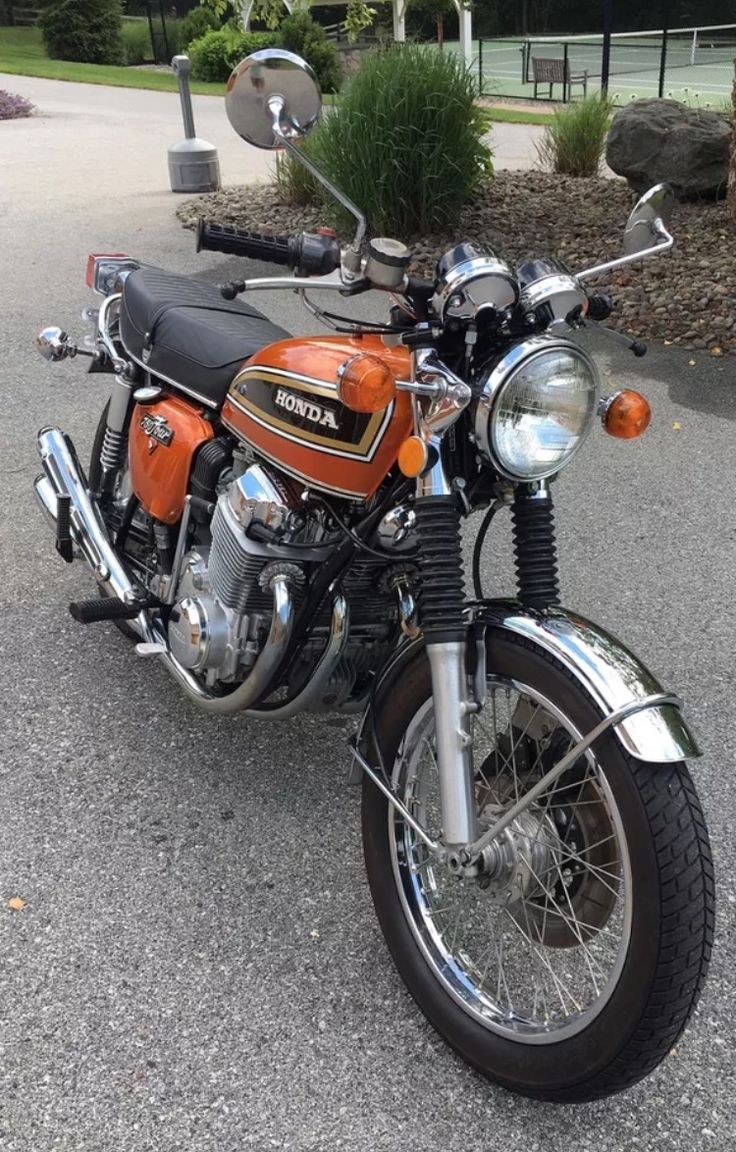 an orange and black motorcycle parked on the street