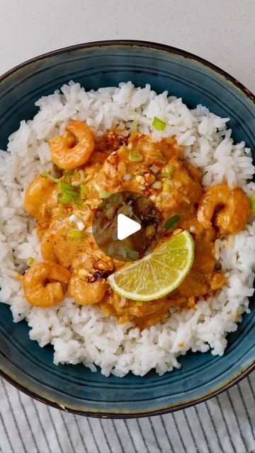 a blue plate topped with rice and shrimp