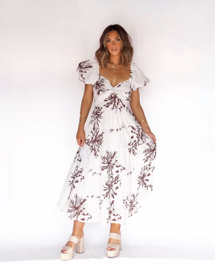 Brown Tropical Midi Dress For Beach With Tropical Print, Tropical Midi Dress For Beach, White Summer Midi Dress For Beach, Breezy White Dress For Vacation, Vacation Maxi Dress With Tropical Print And Short Sleeves, White Short Sleeve Beach Dress For Vacation, White Maxi Dress For Beach Party Vacation, White Floral Print Maxi Dress For Beach Party, White Flowy Maxi Dress For Vacation