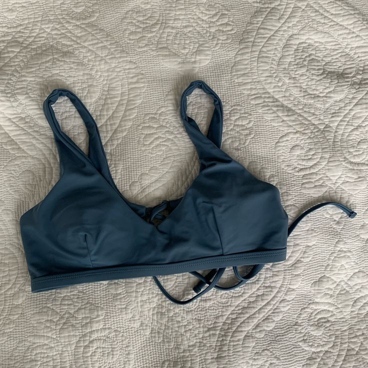 This Bikini Top Is In Great Condition And Was Never Worn. It Comes With Pads And Can Be Removed. The Straps Are Not Functional, However It Has A Functional Tie In The Back. Beach Low-cut Bra With Adjustable Straps, Low-cut Bra With Adjustable Straps For Beach, Adjustable Low-cut Bra For Beach, Blue Strappy Tankini For Swimming, Blue Straps Tankini For Vacation, Blue Beachwear Swimwear With Straps, Blue Tankini With Straps For Poolside, Blue Strapped Swimwear For Beach Party, Blue Strappy Summer Tankini