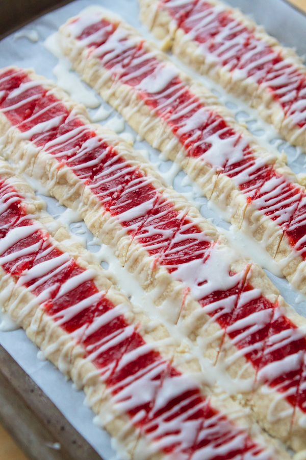 red, white and blue candy sticks are on a baking sheet