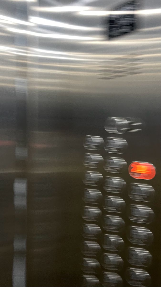 blurry photograph of an orange light on the side of a building