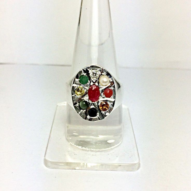 Genuine 925 Sterling Silver Navratan Ring Gemstone - Ruby , Emerald , Blue Sapphire, Yellow Sapphire, Hessonite, Cats Eye, Coral, Pearl, Cubic Zircona. Ring Size - No. ( US ) 8.50 , 11.50 QTY - 1 piece in this listing. The navratna or nine gems influencing the nine planets are: Ruby = Sun , Pearl = Moon, Red Coral = Mars, Emerald = Mercury, Yellow Sapphire = Jupiter, zircon = Venus, Blue Sapphire = Saturn, Hessonite = Rahu , Cat''s Eye = Ketu . Shape - Oval Healing Gemstone Rings In Fine Jewelry Style, Oval Multi-stone Spiritual Rings, Spiritual Multi-stone Oval Rings, Spiritual Oval Multi-stone Rings, Traditional Multi-stone Oval Rings, Traditional Oval Multi-stone Rings, Spiritual Multi-stone Anniversary Rings, Spiritual Multi-stone Rings For Anniversary, Spiritual Gemstone Rings With Round Stone