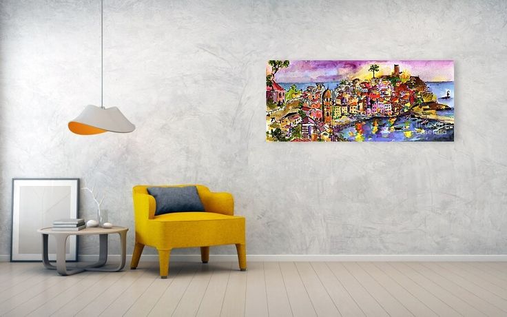 a yellow chair sitting in front of a wall with a painting hanging on it's side