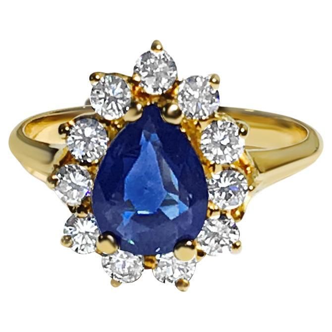 This is a beautiful piece of jewelry made of 18-karat yellow gold. It features a pear-shaped blue sapphire that's 1.50 carats and completely natural. Surrounding the sapphire are round, brilliant-cut diamonds totaling 0.55 carats. All the stones are securely set in a prong setting, showcasing a stunning sparkle in the diamonds and a vibrant blue color in the sapphire. Key Features: 18K Yellow Gold. 1.50 carat 100% earth mined natural blue sapphire. Pear shape sapphire. 0.55 carat diamonds, round brilliant cut diamonds. All stones carefully set in prong setting. Wonderful luster in the diamonds and intense blue color in the sapphire. Blue Sapphire Diamond Ring, Victorian Engagement Rings, Modern Engagement Rings, Gold Cocktail Ring, Gold Cocktail, Blue Sapphire Diamond, Sapphire Diamond Ring, Blue Sapphire Rings, Natural Blue Sapphire