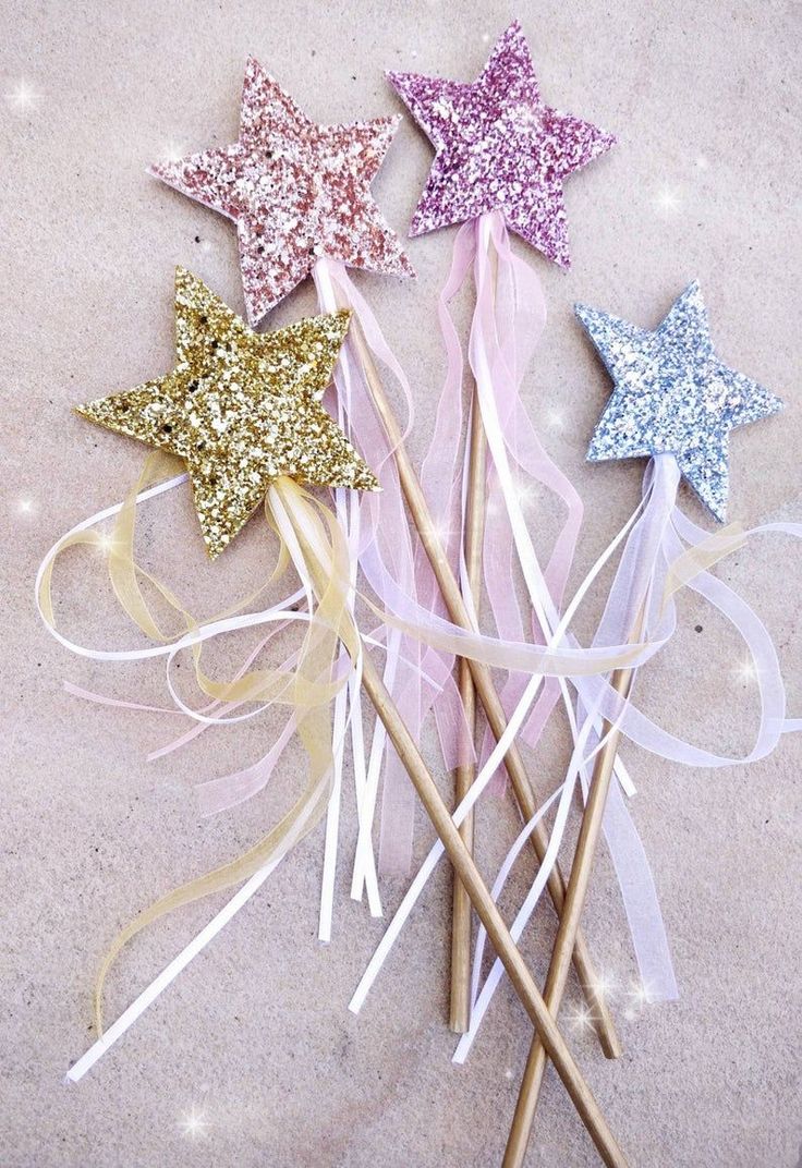 three glitter star wands on top of each other