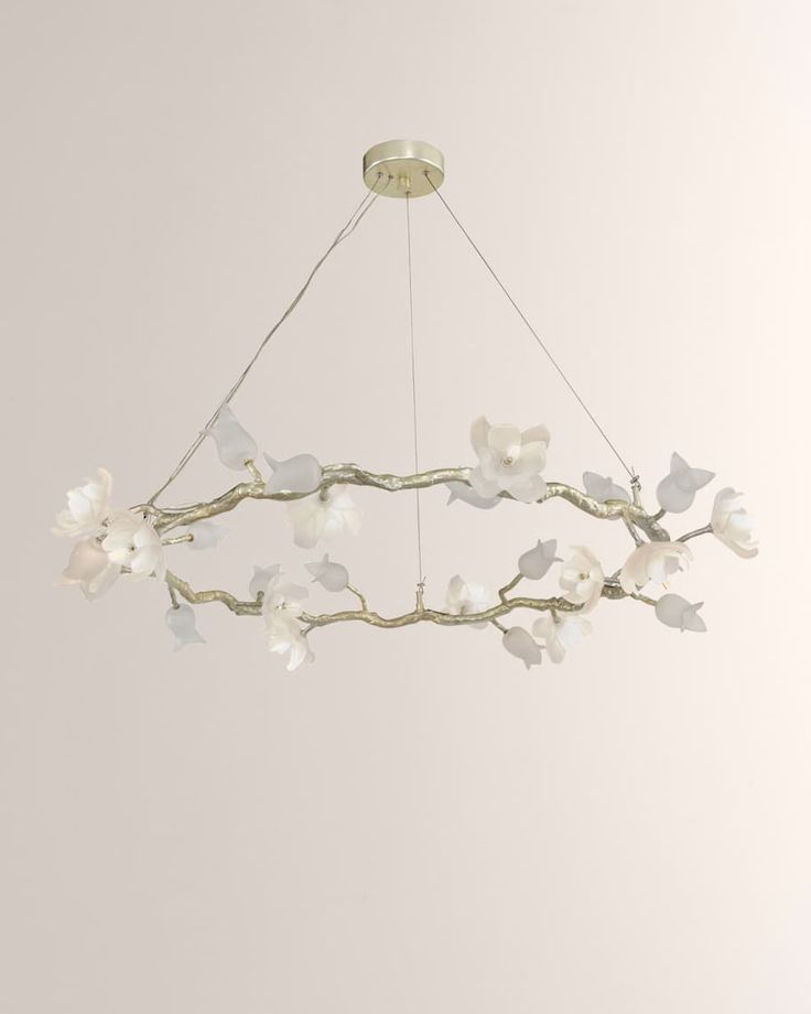 a chandelier with white flowers hanging from it's center and two birds on the branch