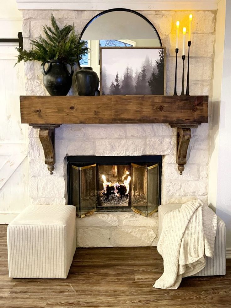 a living room with a fire place in the center and a mirror on the wall