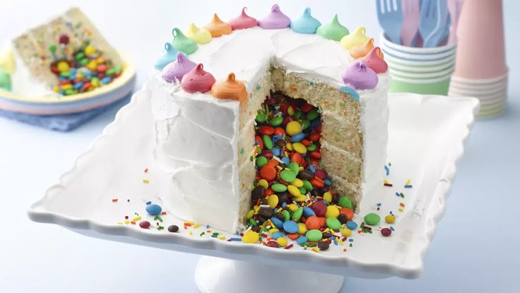 a cake with white frosting and colorful sprinkles