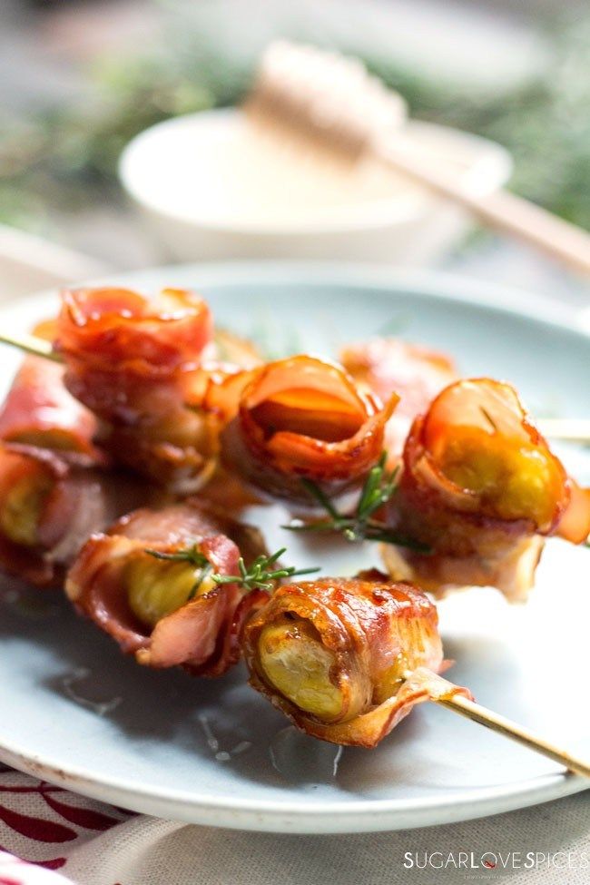 several skewered food items on a white plate