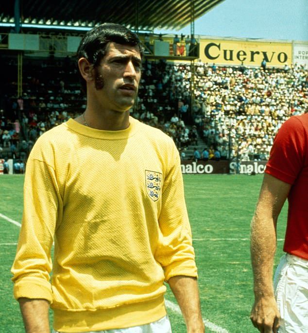 two men standing next to each other on a soccer field