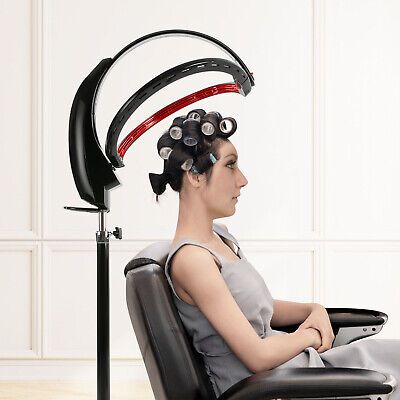 a woman sitting on top of a chair with hair dryer in her head