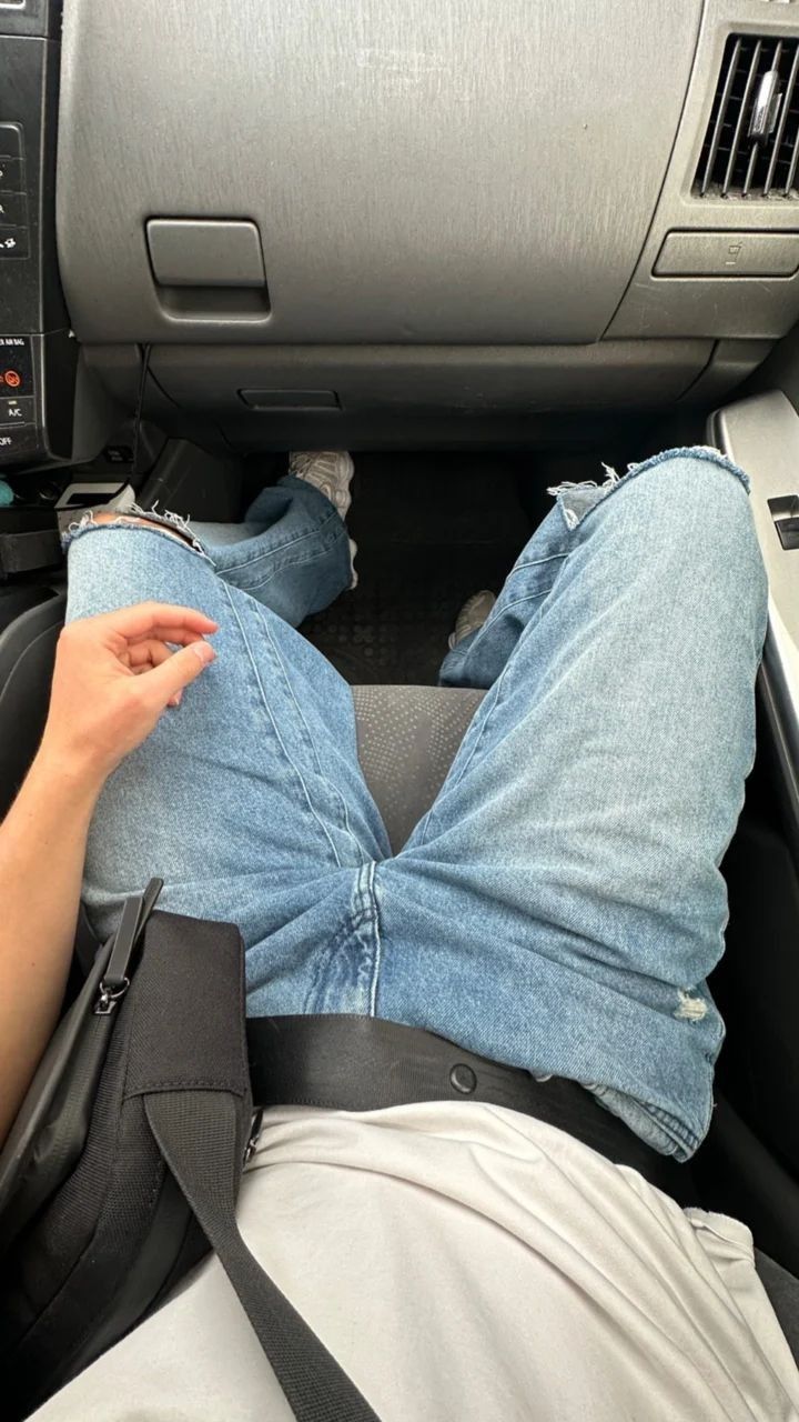 a person laying down in the back seat of a car