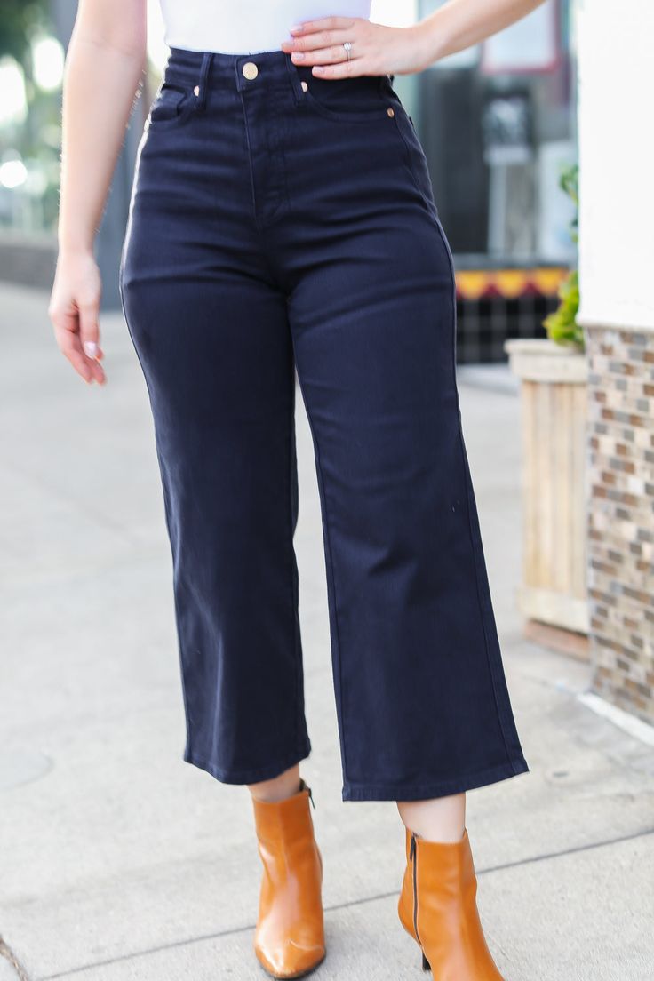 Get ready for fall and stylish layering with these tummy control high-rise wide leg crop jeans. Functional front and back pockets complete these flattering jeans with plenty of stretch. Pair with boots, sandals, heels or flats. Judy Blue Style# 88807 / JB88807 High Rise Zip Fly Control Top 4-Way Stretch Garment Dyed Wide Leg Crop 93% Cotton, 6% Polyester, 1% Spandex True to Judy Blue Sizing Note: the colored Denim from Judy Blue isn't quite as forgiving as the regular denim - if you waver betwee Trendy Medium Wash Wide Leg Pants For Work, Dark Wash Bottoms For Day Out In Fall, Dark Wash Bottoms For Fall Day Out, Trendy Cropped Wide Leg Pants For Fall, Chic Wide Leg Pants In Denim Blue For Fall, High Rise Flare Jeans For Fall Day Out, Versatile Jeans For Fall Day Out, Fall Cropped Leg Jeans For Day Out, Dark Wash Wide Leg Cropped Jeans For Work