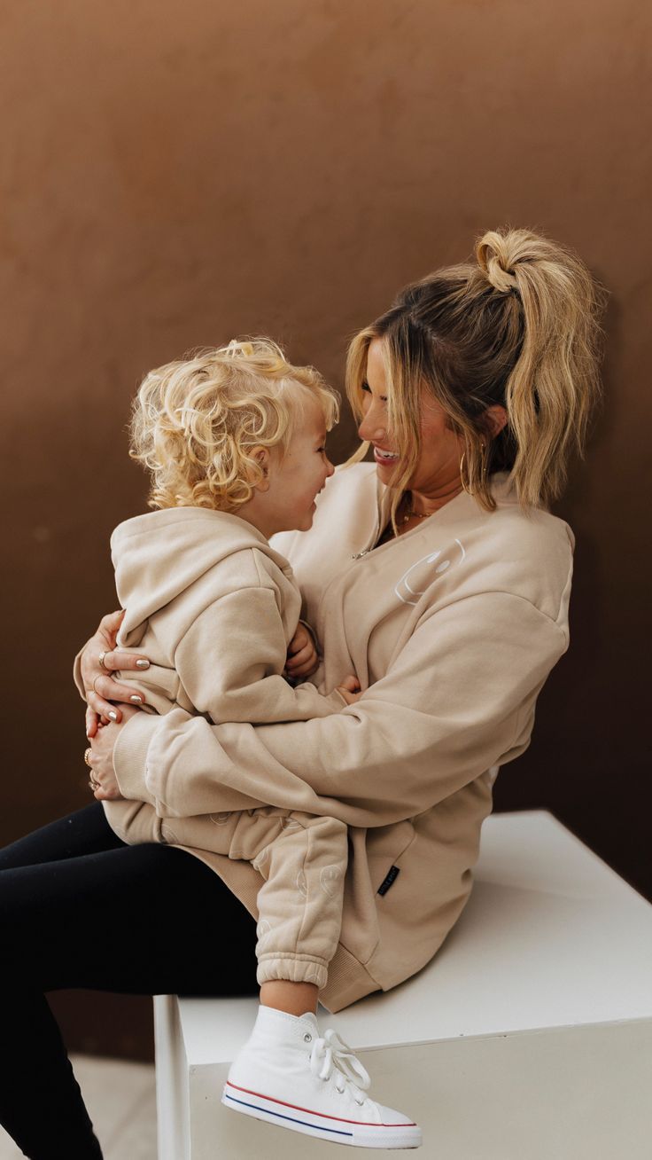 a woman holding a small child on her lap