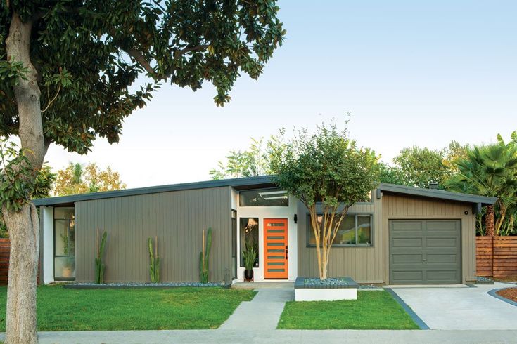 a modern house with an orange front door