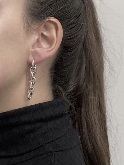 With a high-shine finish, these earrings are made to resemble chain links. Choose to wear just one as an asymmetrical statement piece or get a pair to complete your style. The earring is embellished with our signature logo inside. Ships in custom...