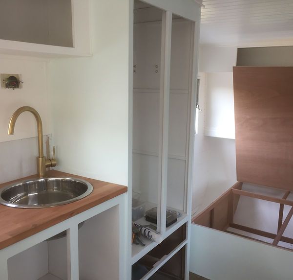 a kitchen with a sink and cupboards in it