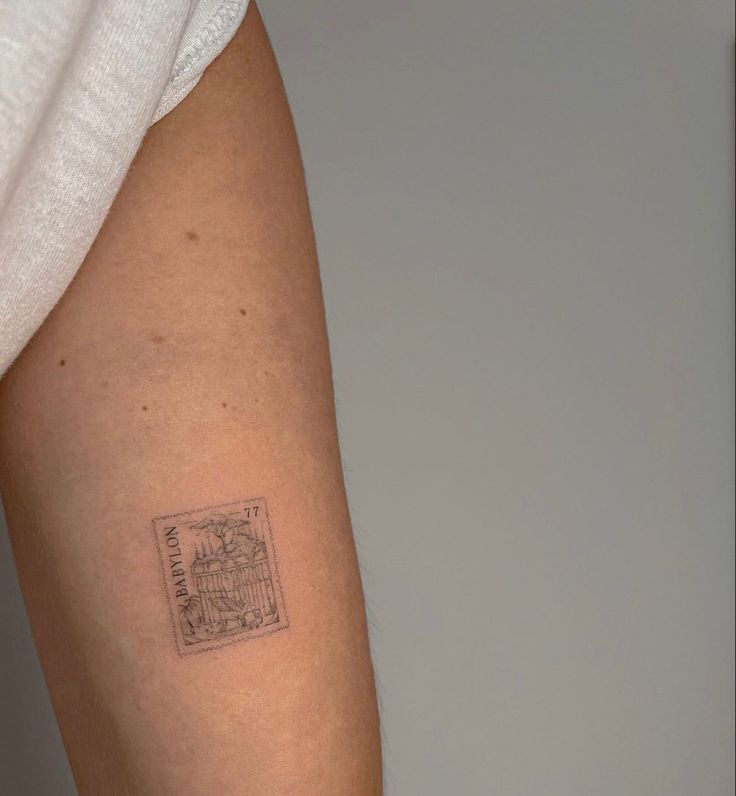 a person with a small tattoo on their left arm and the other arm has a stamp on it